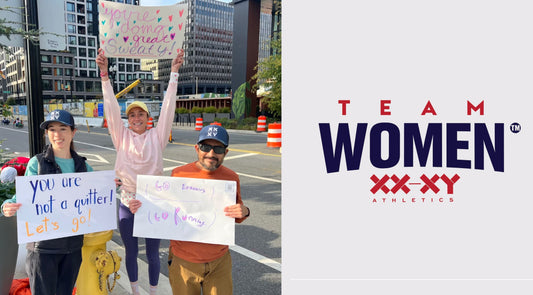 image of team women members holding signs at marathon race