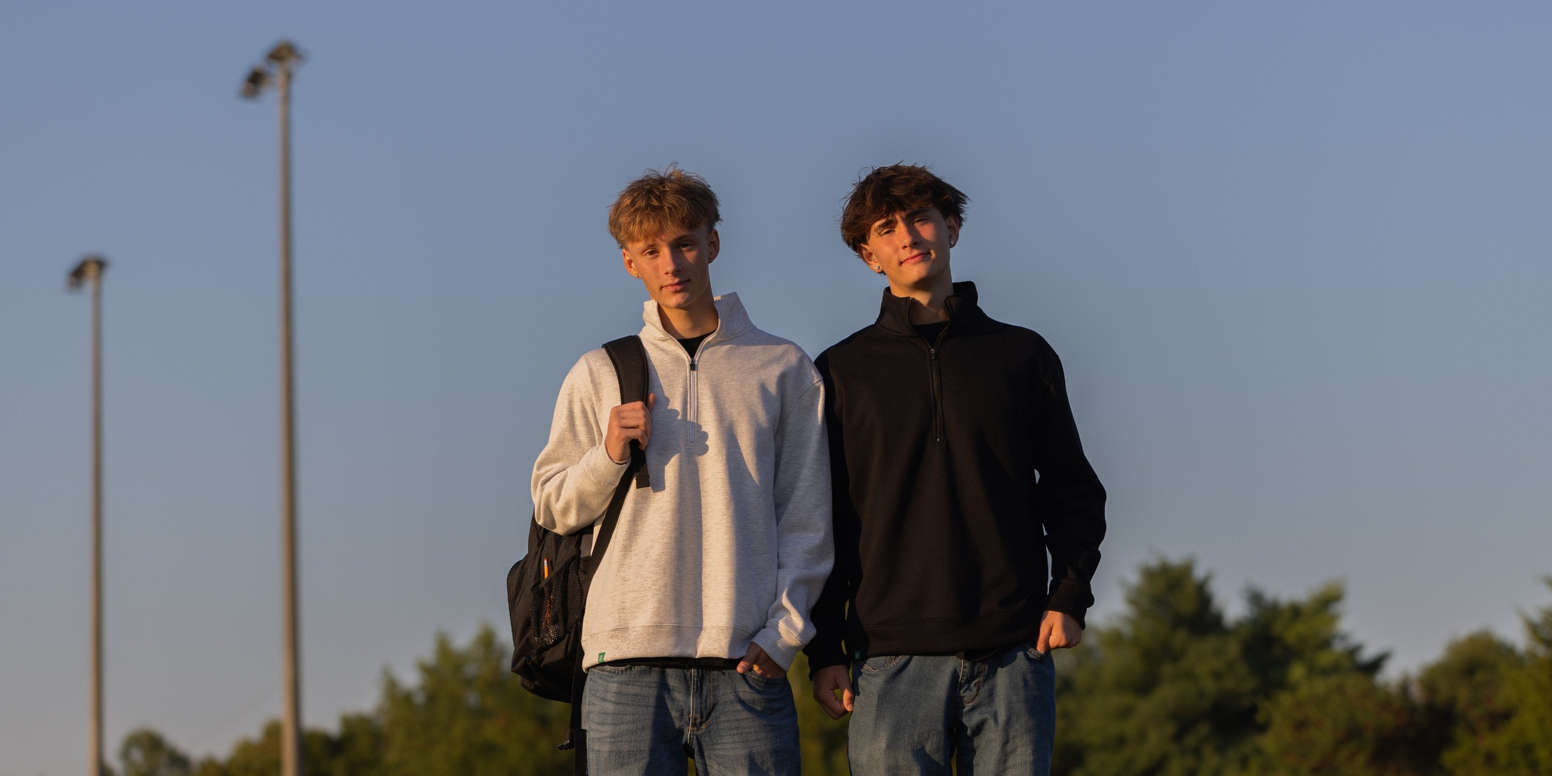 Two boys showcasing their back to school outfits, wearing XX-XY Fearless Fleece zip in the colors black and white.