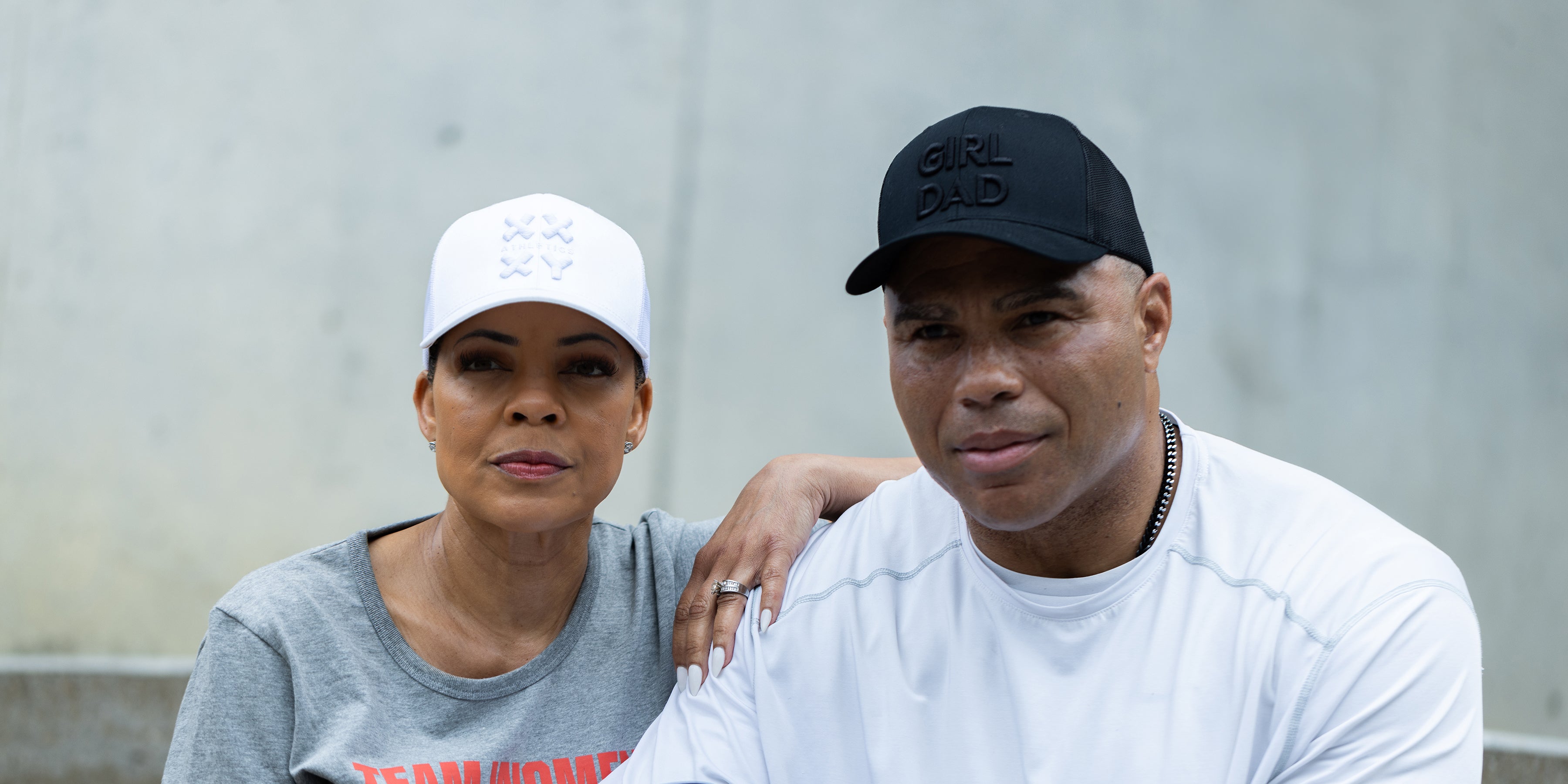 A man and woman wearing their XX-XY whiteout and blackout trucker caps. 