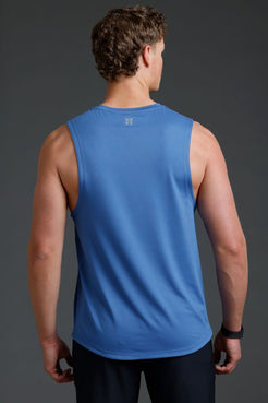 Man wearing a blue sleeveless shirt on a gray background || Cobalt Blue