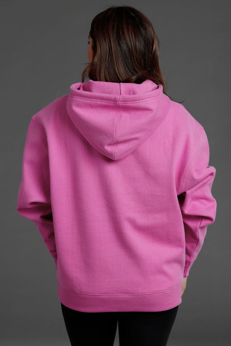 Person wearing a pink hoodie on a gray background || Bright Fuchsia