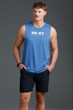 Man wearing a blue sleeveless shirt with a logo on a gray background || Cobalt Blue