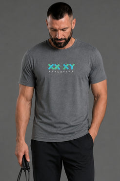 Man wearing a gray t-shirt with 'XXY Athletics' logo on a gray background || Black/Dark Heather Gray/Light Heather Gray