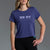 Woman wearing a blue 'XXXY Athletics' t-shirt on a gray background || Indigo