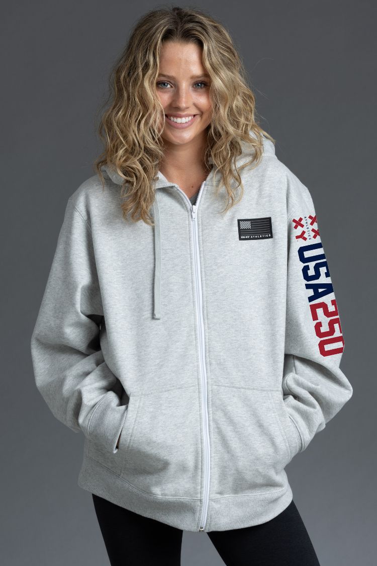 Woman wearing a gray hoodie with 'USA 250' design on a gray background