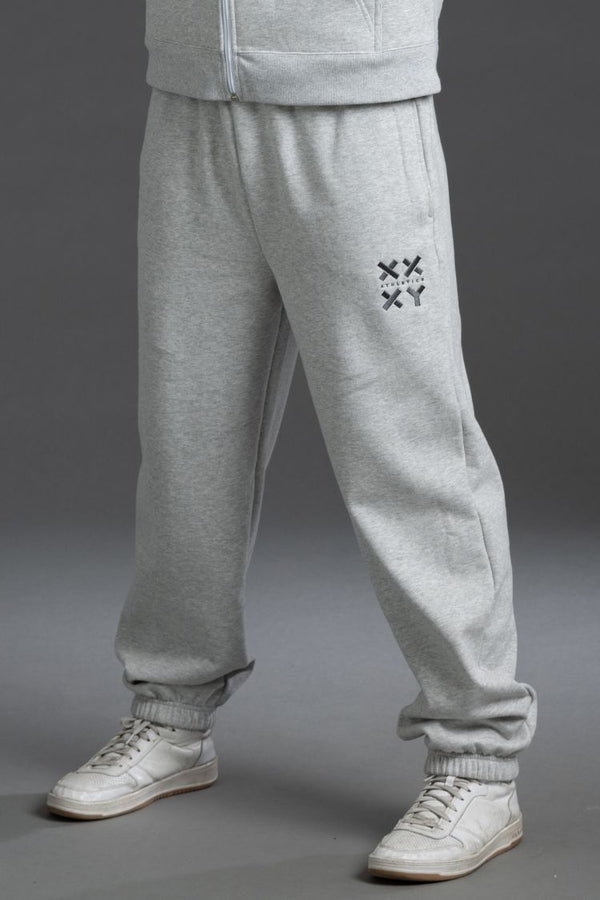 Gray sweatpants with a logo on the leg against a gray background || Light Heather Gray