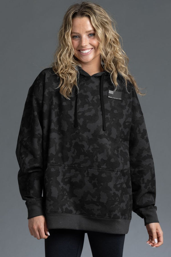 Woman wearing a black camouflage hoodie on a gray background || Black Camo