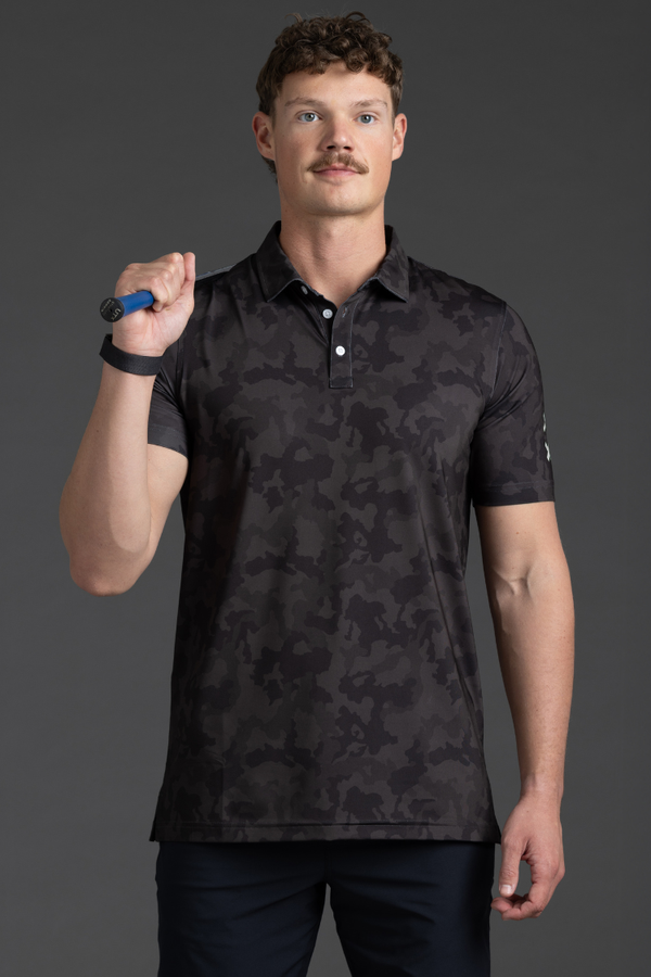 Man wearing a black camouflage polo shirt against a gray background || Black Camo