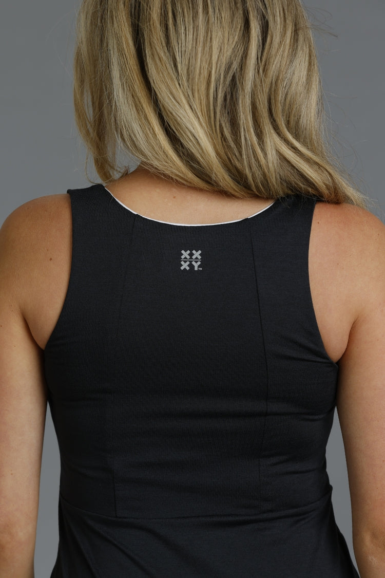 Black tank top with a logo on the back against a gray background || Black