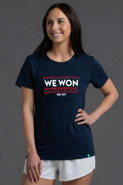 Woman wearing a navy blue t-shirt with 'WE WON 25 MORE STATES TO GO' text on a gray background || Navy