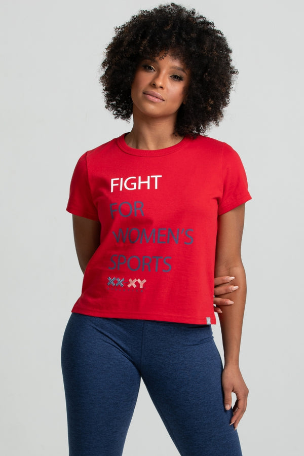 Person wearing a red t-shirt with 'Fight for Women's Sports' text on a gray background || Red