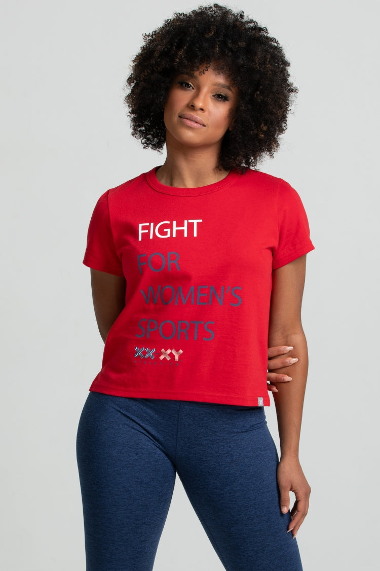 Person wearing a red t-shirt with 'Fight for Women's Sports' text on a gray background || Red