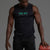 Man wearing a black sleeveless shirt with a logo, holding a red basketball on a gray background || Black