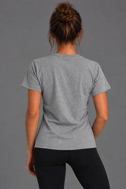 Back view of woman wearing the gray Stand Up Save Women’s Sports tee with black leggings || Heather Gray