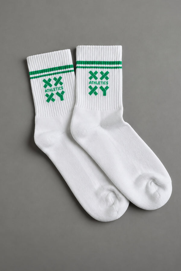 White socks with green stripes and logos on a gray background || white