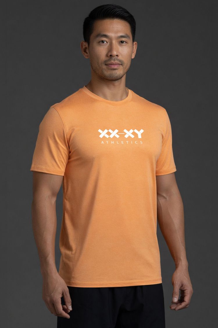 Man wearing an orange t-shirt with a logo on a dark background || Light Orange