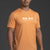 Man wearing an orange t-shirt with a logo on a dark background || Light Orange