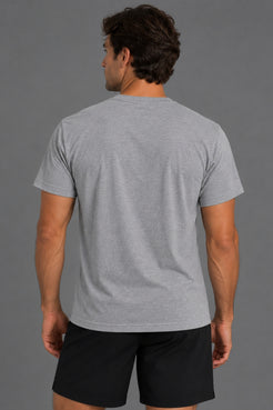 Back view of male model wearing a plain gray T-shirt with black athletic shorts against a gray background. || Heather Gray