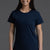 Woman wearing a navy blue t-shirt and white shorts on a gray background || Navy