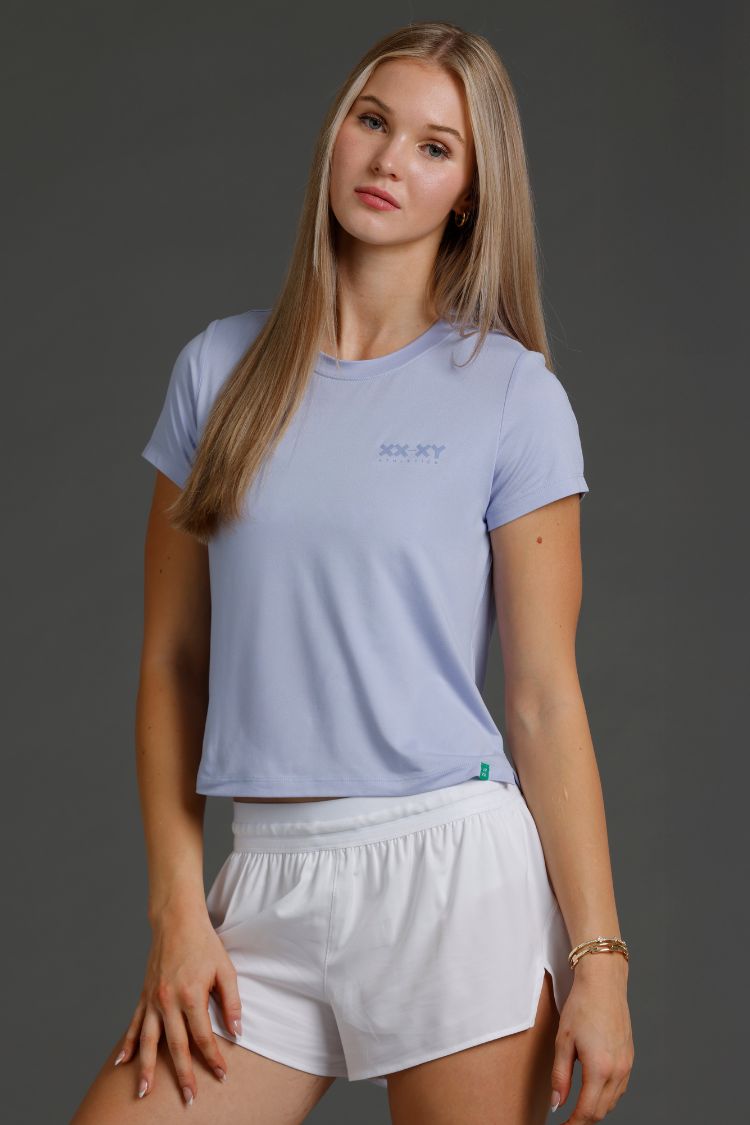 Woman wearing Lavender t-shirt and white shorts