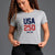 Woman wearing a gray t-shirt with 'USA 250' print on a gray background || Heather Gray