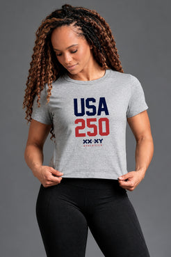 Woman wearing a gray t-shirt with 'USA 250' print on a gray background || Heather Gray