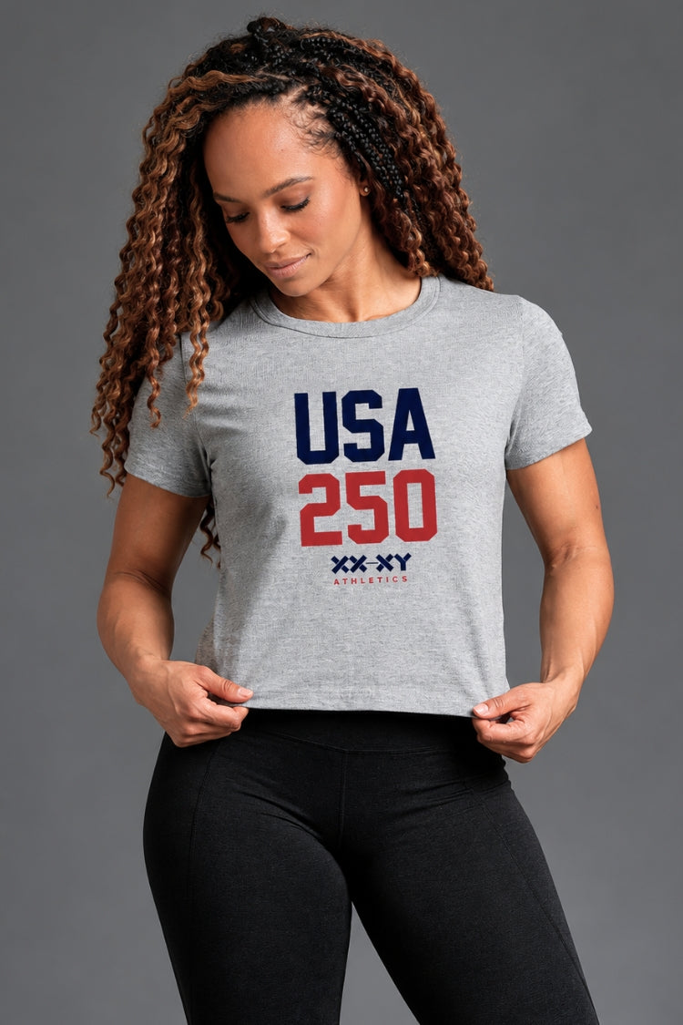 Woman wearing a gray t-shirt with 'USA 250' print on a gray background || Heather Gray