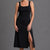Woman wearing a black sleeveless dress with a slit on a gray background || Black