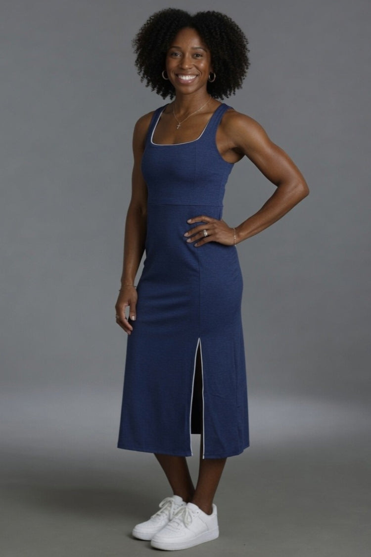 Woman wearing a blue dress with a gray background || Navy