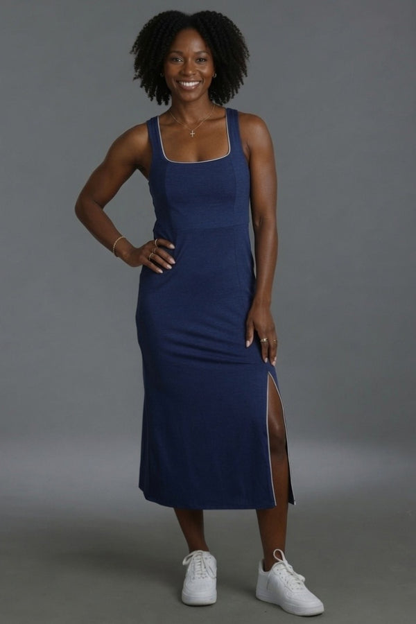 Woman wearing a blue dress with a gray background || Navy
