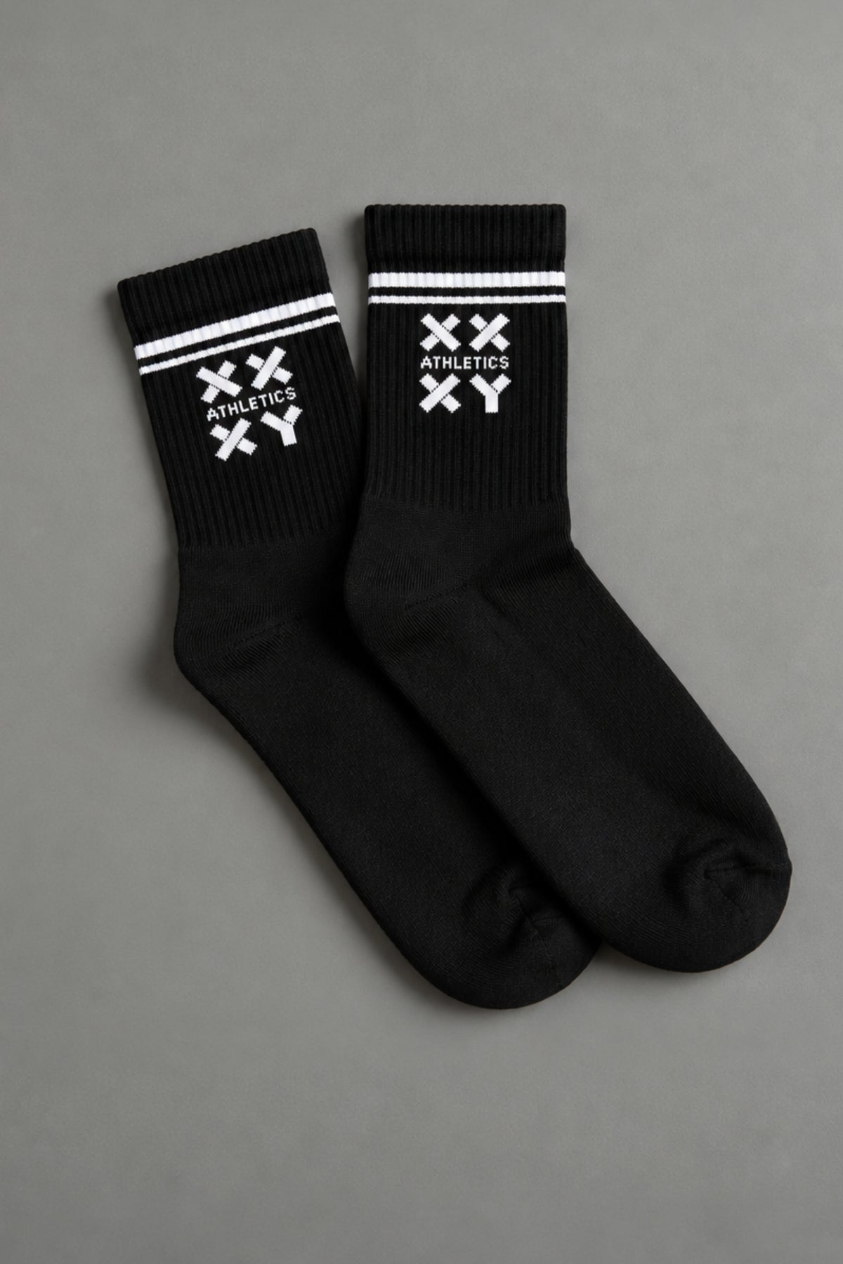 Black socks with white logo on a gray background || black