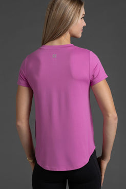 Woman wearing a pink t-shirt on a gray background || Bright Fuchsia