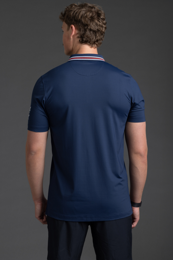 Person wearing a navy blue athletic shirt and shorts on a gray background || Navy