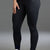 Person wearing black leggings with a logo and white sneakers  || Black