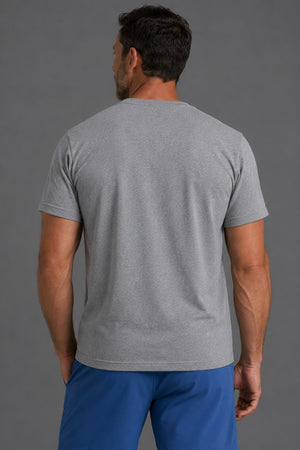 A man viewed from the back wearing a heather gray short-sleeve crewneck t-shirt and blue pants, set against a solid gray studio background. || Gray Camo