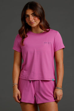 Woman wearing a pink t-shirt and shorts set with a brand logo || Bright Fuchsia