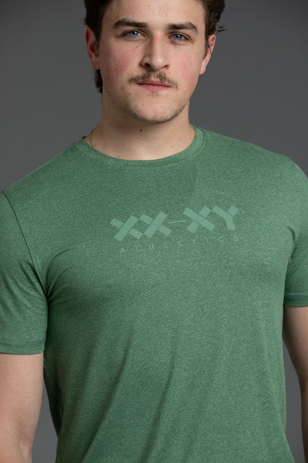 Man wearing a green t-shirt with a xx-xy logo on a gray background || Hunter Green Heather