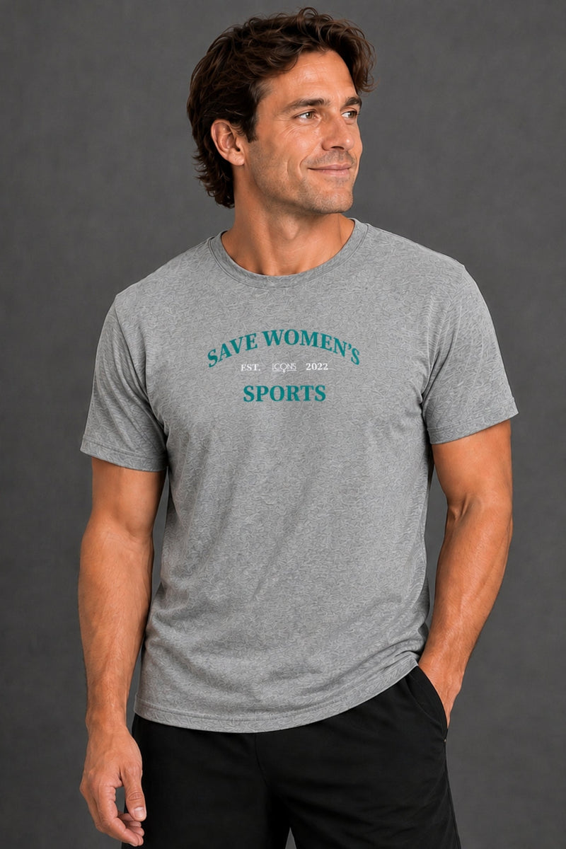 A man wearing a heather gray crewneck t-shirt with the text 'SAVE WOMEN'S SPORTS' printed in teal on the chest, posed against a dark gray studio background. || Heather Gray