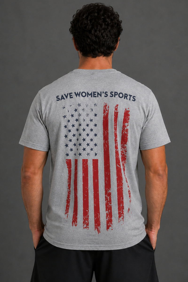 A man viewed from behind wearing a heather gray t-shirt with a distressed American flag graphic and the text 'SAVE WOMEN'S SPORTS' printed across the upper back. || Heather Gray