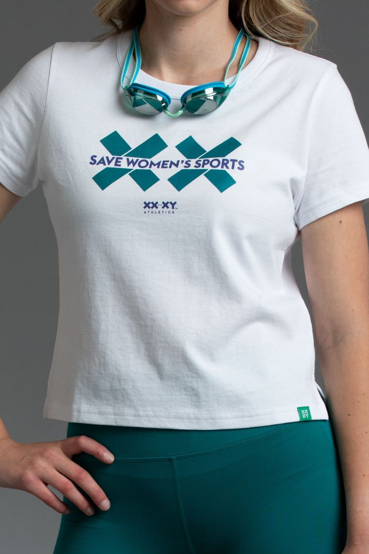 Person wearing a white t-shirt with 'Save Women's Sports' text and teal goggles on a gray background || Teal
