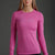 Woman wearing a pink long-sleeve shirt with a logo on a gray background || Bright Fuchsia
