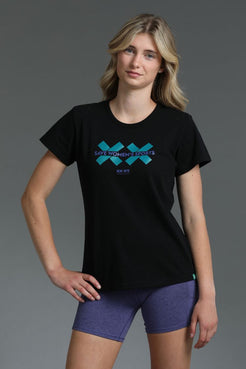 Woman wearing a black t-shirt with a blue logo on a gray background || Teal