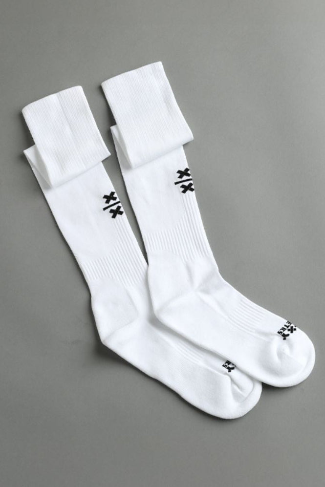 Two white socks with black logo on a gray background || White