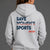 A woman viewed from behind wearing a light gray hoodie with a graphic on the back that reads 'SAVE WOMEN'S SPORTS' in navy and red, plus 'XX-XY SPORTS' below. She is also wearing black athletic shorts against a plain gray studio background. || Heather Gray