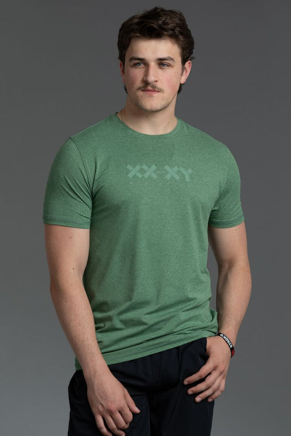 Man wearing a green t-shirt with a xx-xy logo on a gray background || Hunter Green Heather