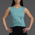 Woman wearing a teal sleeveless top and black pants against a gray background || Underseas