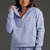 Woman wearing a Lavender tracksuit with a logo on a dark background || Lavender Gray