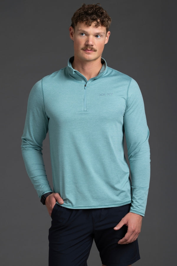 Man wearing a light blue long-sleeve shirt against a gray background || Underseas
