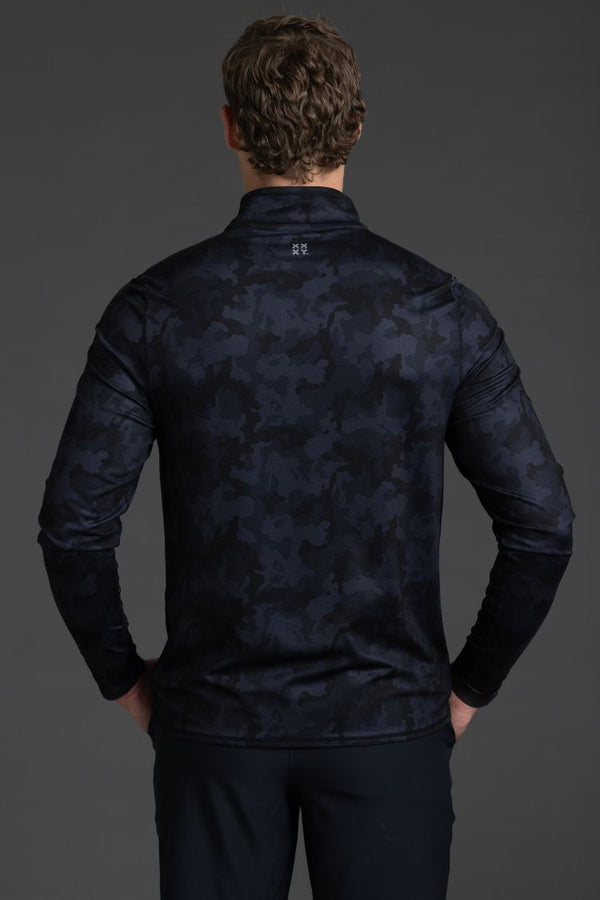 Person wearing a dark patterned jacket on a gray background || Black Camo