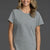 Woman wearing a gray t-shirt and white shorts on a gray background || Heather Gray
